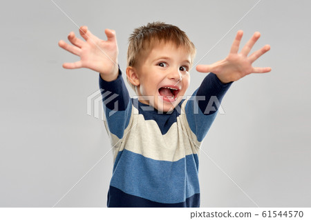 portrait of scared little boy in striped pullover 61544570