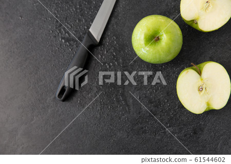 green apples and kitchen knife on slate background green apples and kitchen knife on slate background 61544602