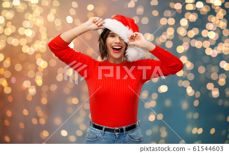 happy young woman in santa hat on christmas happy young woman in santa hat on christmas 61544603