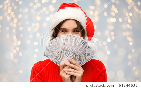 happy woman in santa hat with money on christmas 61544635