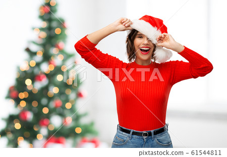 happy young woman in santa hat on christmas happy young woman in santa hat on christmas 61544811