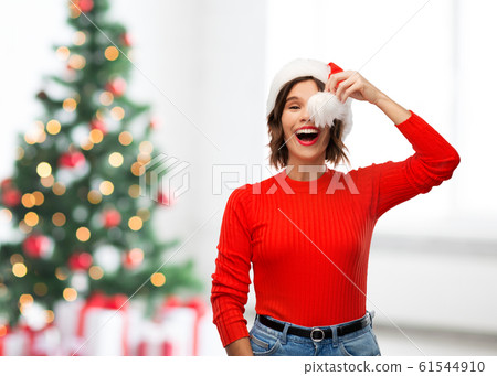 happy young woman in santa hat on christmas 61544910