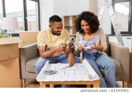 couple with blueprint counting money at home couple with blueprint counting money at home 61545061