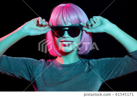 happy woman in pink wig and black sunglasses happy woman in pink wig and black sunglasses 61545171