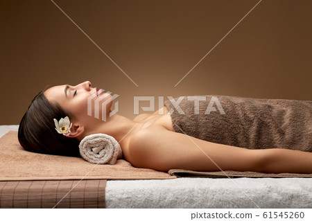 young woman lying at spa or massage parlor 61545260