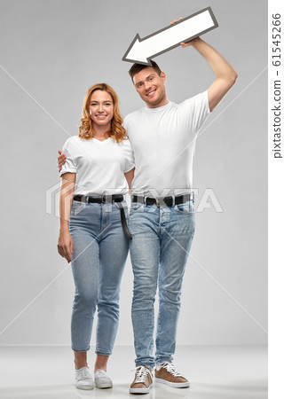 happy couple in white t-shirts with arrow to left happy couple in white t-shirts with arrow to left 61545266