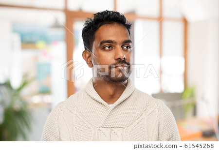 indian man in sweater over office background indian man in sweater over office background 61545268