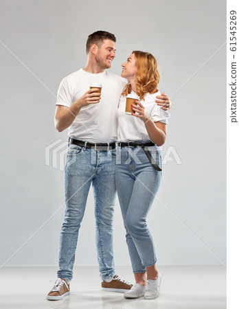 portrait of happy couple with takeaway coffee cups portrait of happy couple with takeaway coffee cups 61545269