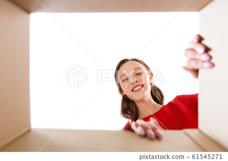 happy young woman looking into open gift box happy young woman looking into open gift box 61545271
