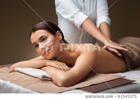 woman lying and having back massage at spa 61545273