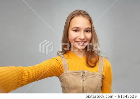 happy teenage girl taking selfie happy teenage girl taking selfie 61545529