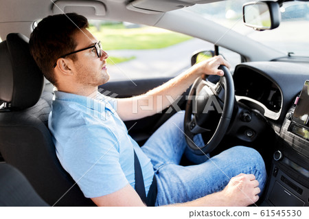 man or driver in glasses driving car in summer man or driver in glasses driving car in summer 61545530