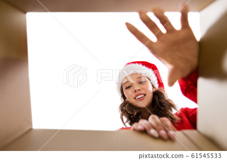happy young woman looking into open christmas gift happy young woman looking into open christmas gift 61545533