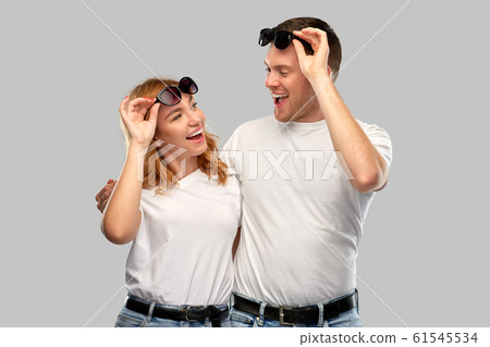 happy couple in white t-shirts and sunglasses 61545534