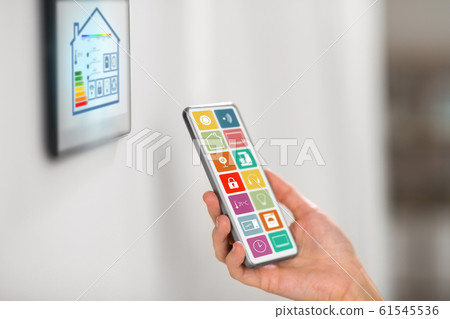 hand with smart home icons on smartphone screen hand with smart home icons on smartphone screen 61545536