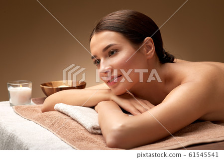 young woman lying at spa or massage parlor young woman lying at spa or massage parlor 61545541