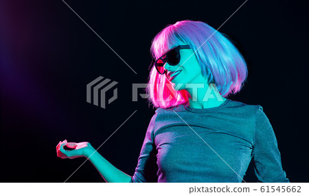 happy woman in pink wig and sunglasses dancing happy woman in pink wig and sunglasses dancing 61545662