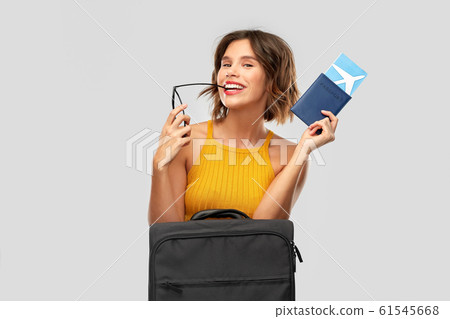 happy young woman with air ticket and travel bag happy young woman with air ticket and travel bag 61545668