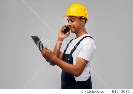 indian builder with clipboard calling on cellphone indian builder with clipboard calling on cellphone 61545671