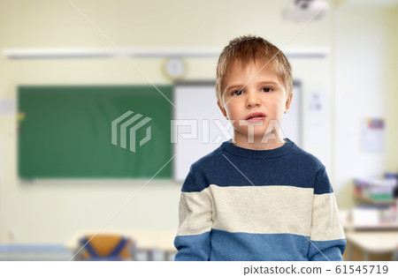 little boy in striped pullover at school 61545719
