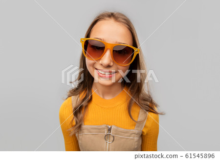 smiling young teenage girl in sunglasses smiling young teenage girl in sunglasses 61545896