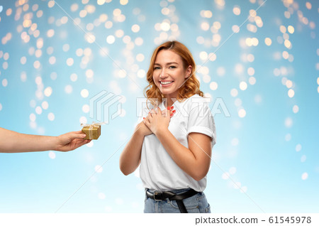 happy couple in white t-shirts with christmas gift happy couple in white t-shirts with christmas gift 61545978