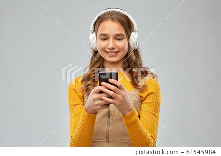 teenage girl in headphones listening to music 61545984