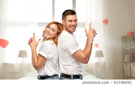 happy couple making gun gesture on valentines day 61546092