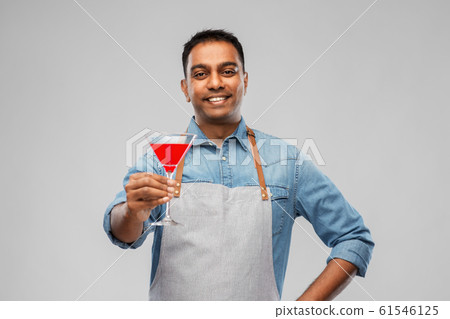 indian barman in apron with glass of cocktail 61546125