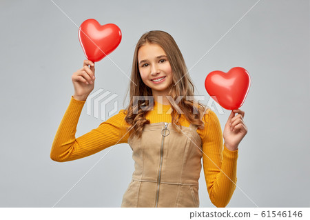 happy teenage girl with red heart-shaped balloons happy teenage girl with red heart-shaped balloons 61546146