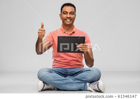 happy indian man with tablet pc showing thumbs up 61546147