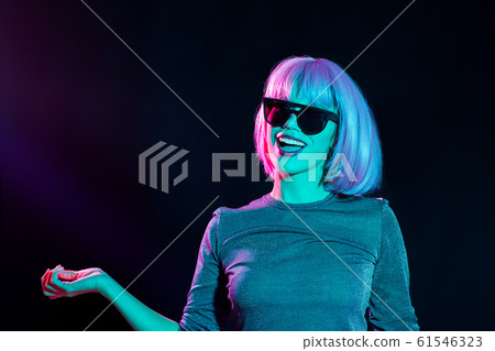 happy woman in pink wig and sunglasses dancing happy woman in pink wig and sunglasses dancing 61546323