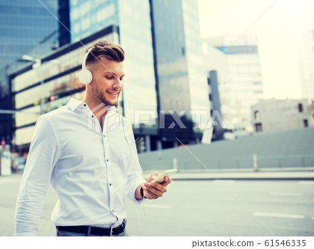 man with headphones and smartphone listening music 61546335