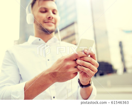 man with smartphone and headphones listening music man with smartphone and headphones listening music 61546363