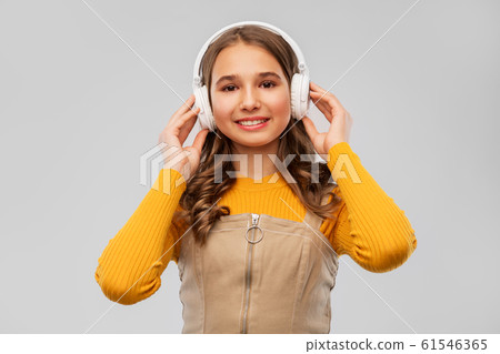 teenage girl in headphones listening to music teenage girl in headphones listening to music 61546365