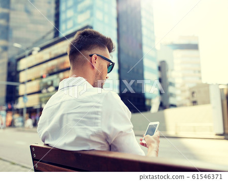 close up of man texting on smartphone in city close up of man texting on smartphone in city 61546371