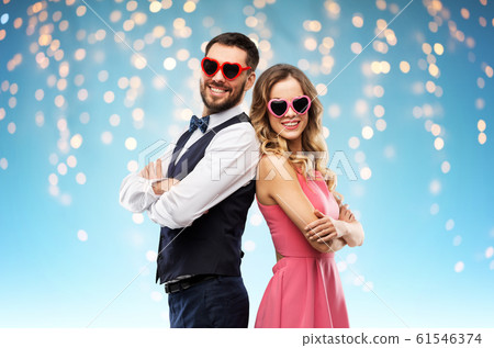 happy couple in heart-shaped sunglasses happy couple in heart-shaped sunglasses 61546374