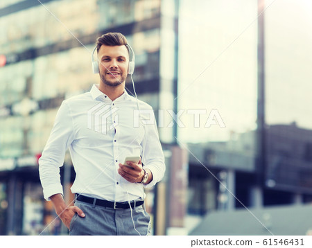 man with headphones and smartphone listening music 61546431