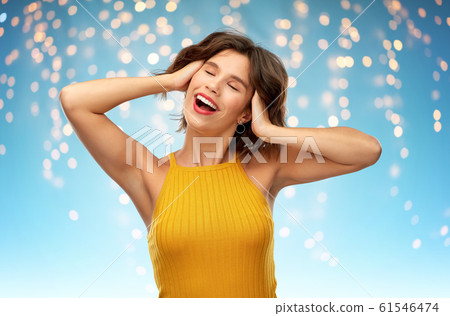 happy laughing young woman in yellow top 61546474