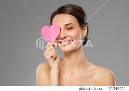 beautiful woman closing one eye with pink heart beautiful woman closing one eye with pink heart 61546631