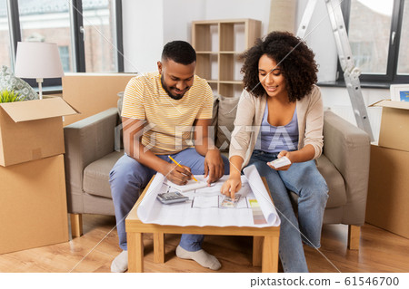 couple with blueprint counting money at home couple with blueprint counting money at home 61546700