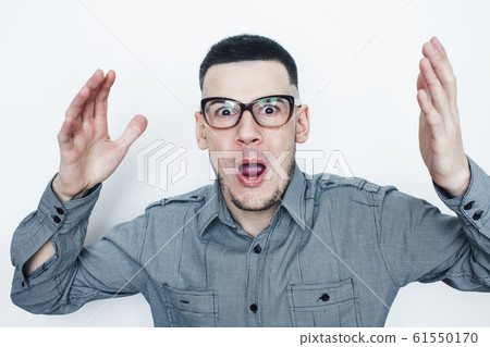 young handsome teenage hipster guy posing emotional wearing glasses, happy smiling lifestyle people concept 61550170