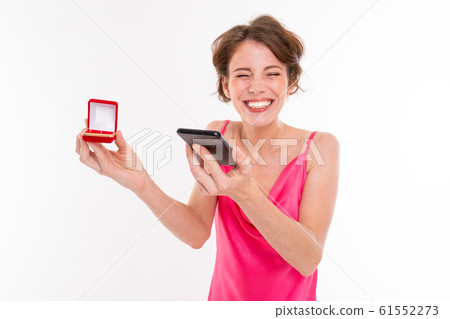 happy girl with box with engagement ring phoning tell news to friend on white background 61552273