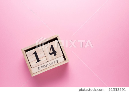 Wooden calendar with the inscription February 14 on a pink isolated background. Wooden calendar with the inscription February 14 on a pink isolated background. 61552391