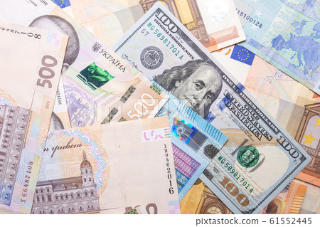 Dollar euro hryvnia closeup. The texture of the currencies of different countries. 61552445
