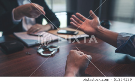 Police officer interrogating suspect or criminal Police officer interrogating suspect or criminal 61554159