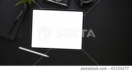 Blank screen tablet and office supplies in dark 61554277