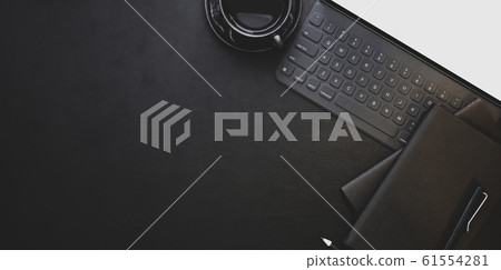 Overhead shot of dark trendy workplace with office Overhead shot of dark trendy workplace with office 61554281