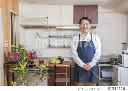 Middle age man cooking in kitchen 61554326