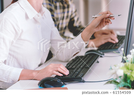 Pensive programmer working on desktop pc Pensive programmer working on desktop pc 61554509